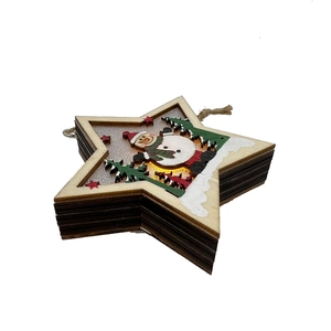 Detail of wooden star-shaped Christmas LED light ornament with snowman and tree pattern