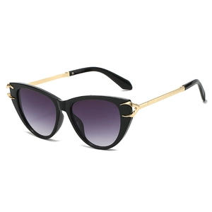 Chic cat-eye sunglasses with black frames, gold metal temples, and purple gradient lenses