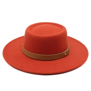 Orange flat top wool felt fedora with brown leather band and gold metal rivet detail