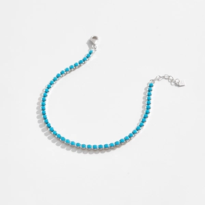Macro detail of S925 sterling silver bracelet featuring turquoise blue beads and lobster clasp