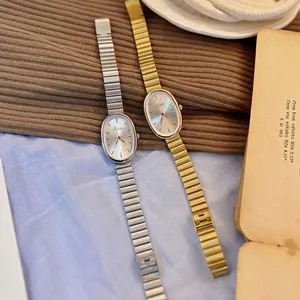 Vintage oval dial quartz watch for women in gold and silver finish with metal link strap