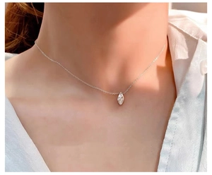 Close-up of minimalist S925 silver necklace with marquise cut sparkling zircon on neck