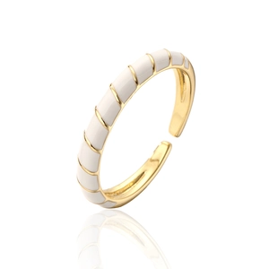 Detail of gold-plated spiral ring with white enamel finish and adjustable open band