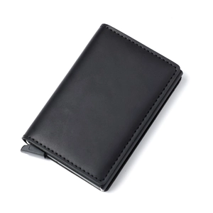 Macro shot of slim RFID blocking wallet with black leather texture and popup slide lever