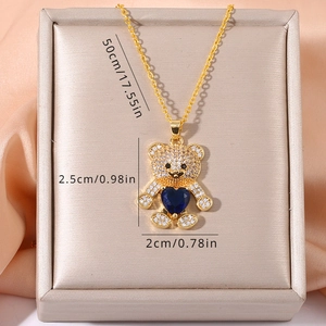 Detailed view of 50cm gold chain necklace with blue heart bear pendant and white zircons