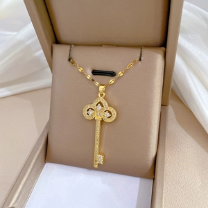 Luxury gold crown key necklace with sparkling crystals in a premium gift box display