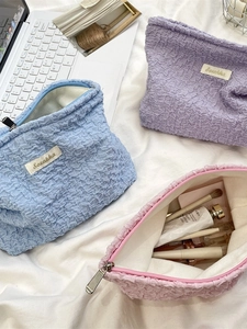 Bubble texture cosmetic bag in blue, purple, and pink with spacious zipper design