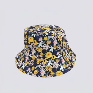 Detailed top view of navy blue floral bucket hat with yellow and pink flower patterns