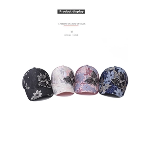 Detailed view of lace floral baseball caps in four colors with rhinestone butterfly accents