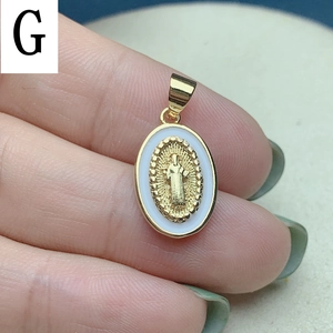 Macro detail of oval Jesus pendant with gold relief and white enamel border inlay