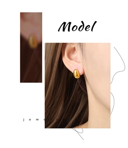 Close-up of minimalist 18K gold plated oval stud earring on a female model's ear
