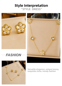 Detailed set of gold plated flower necklace and earrings with clear crystal stones