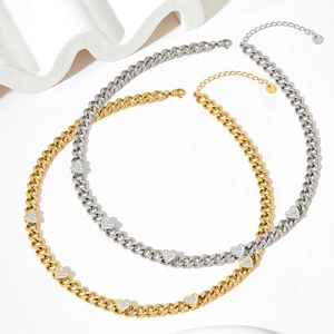 Gold and silver Cuban chain necklaces with heart-shaped zircon pendants on white background