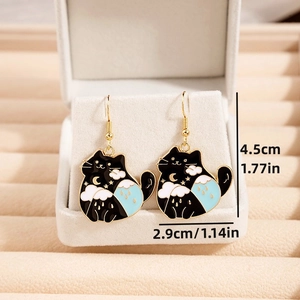 Close-up of black cat enamel earrings with moon and cloud details showing size 4.5cm