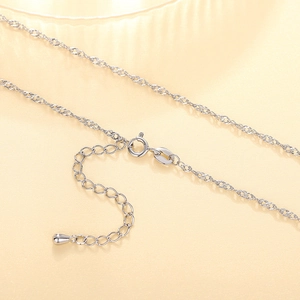 Macro view of silver water wave chain necklace with spring clasp and adjustable links