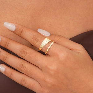 Close-up of golden minimalist irregular double-layer open ring on model finger