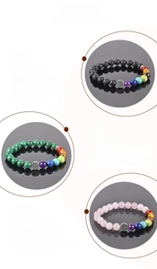Detail of tree of life charm bracelets featuring chakra beads and natural volcanic stone