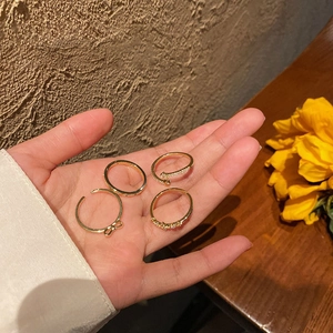 Set of four gold bow rings for women featuring sparkling accents and adjustable open design