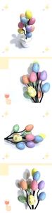 Detail of colorful Easter egg tree in white pot with speckled pastel macaron eggs