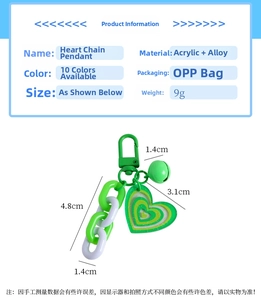 Detail of green acrylic heart keychain with bells and glitter finish showing dimensions