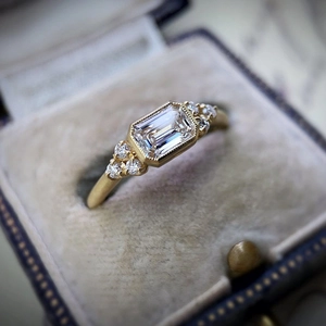 Anillo vintage de oro con diamante corte esmeralda en caja de terciopelo azul
