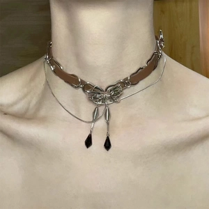 Detail of brown leather choker with silver bow pendant and black crystal teardrops