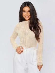 Detail showing the sheer striped texture of the beige long sleeve knit top on a model