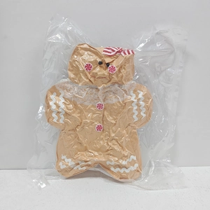 Gingerbread man plush pillow shown in vacuum-sealed transparent plastic packaging