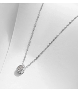 Macro detail of S925 silver necklace featuring a teardrop pendant with sparkling cubic zirconia