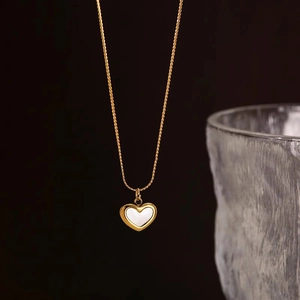 Titanium steel heart necklace with white shell inlay on a delicate golden chain