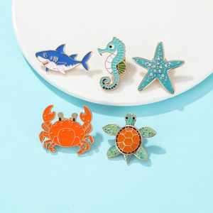 Detailed set of 5 colorful enamel ocean creature pins with shark, sea horse, and turtle