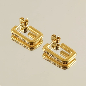Macro detail of 18K gold stainless steel rectangular hoop earrings with pavé crystals