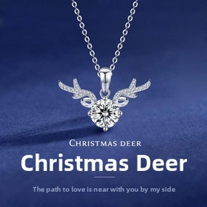 Macro view of Christmas deer necklace with brilliant round stone and silver antlers