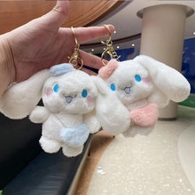 Detail of plush bunny keychains featuring cute blue and pink accessories on soft fur