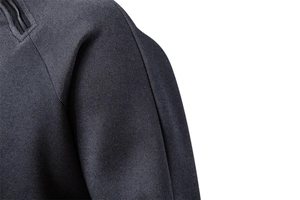 Detailed macro view of dark grey tech fabric with high-quality zipper and shoulder seam