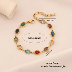 Macro detail of multi-colored oval glass gemstone bracelet with adjustable gold chain