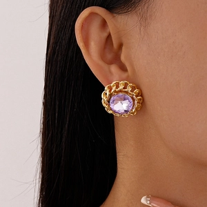 Detailed close-up of a vintage chain-edge earring featuring a large purple gemstone