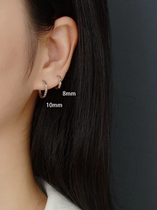 Side view of 8mm and 10mm S925 silver hoop earrings with rainbow stones on ear lobe