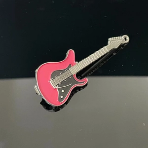 Detailed view of pink electric guitar alloy hair clip with glossy enamel finish