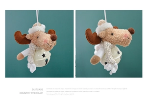 Detail of plush reindeer Christmas ornament with large star-cutout metal bell and scarf