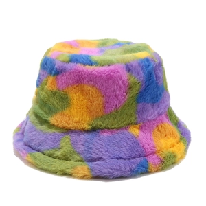 Detail shot of the plush faux fur texture on a colorful tie-dye winter bucket hat