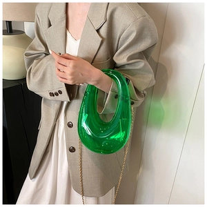 Green acrylic evening box bag with gold chain strap and stylish horseshoe-shaped handle