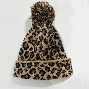 Trendy leopard print knit beanie with a fluffy faux fur pompom for winter warmth