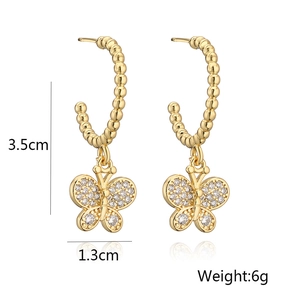 Detail view of gold butterfly earrings with size markings and weight specifications