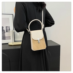 Detail of small crossbody bag featuring beige flap with circular lock and khaki suede body