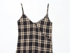 Detail of V-neck plaid camisole with frayed edges and brown checkered pattern