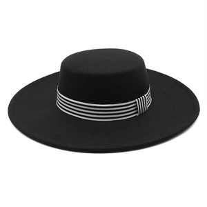 Black wool felt boater hat with a chic black and white striped ribbon band and bow