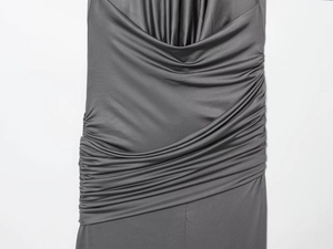 Detail of dark grey ruched dress featuring elegant pleats and metallic ring hardware