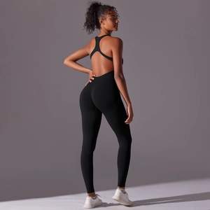 Close-up of seamless black yoga jumpsuit featuring a racerback cutout and open back detail