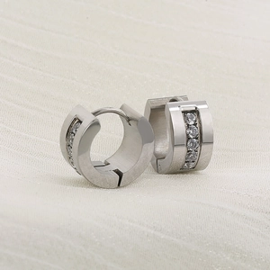 Close-up of silver steel hoop earrings featuring vertically set white round cubic zirconia